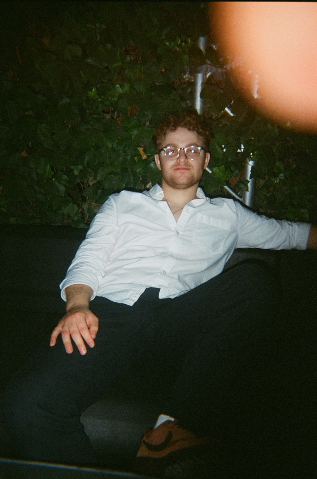Alexis Bardini, photographed on film against an ivy wall